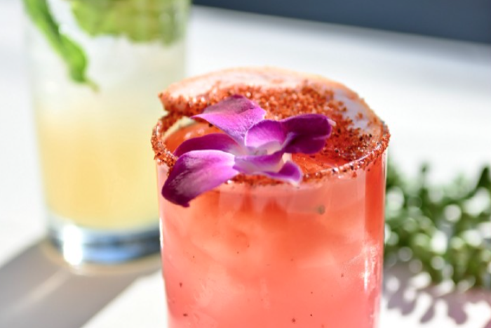 cocktail topped with a pink flower